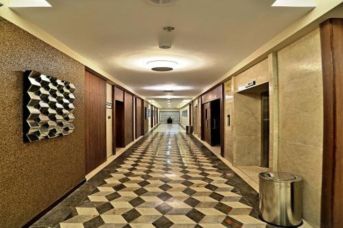 a hallway with a checkered floor in a building at VITS Devbhumi, Dwarka in Dwarka