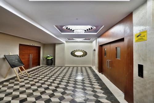 a hallway with a checkered floor in a building at VITS Devbhumi, Dwarka in Dwarka