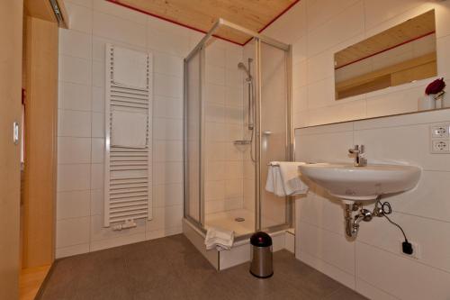 a bathroom with a sink and a shower at Fewo-Kerschbaum in Bad Windsheim