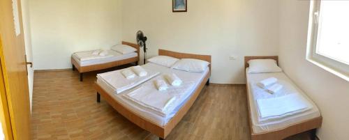 a room with two beds and a window at Guesthouse Soče in Međugorje