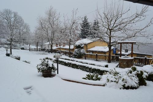 a yard covered in snow with a gazebo at Agriturismo E Turre in Serrastretta