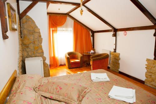 a bedroom with a bed and a living room at Ideal Hotel in Vinnytsya