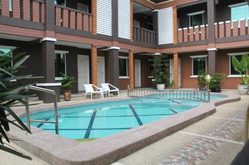 a swimming pool in front of a building at Myvilla Langkawi Hotel in Pantai Cenang