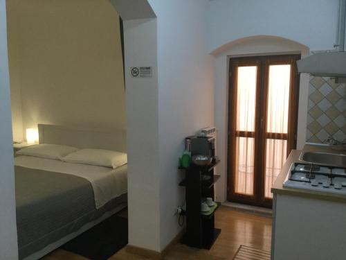 En eller flere senger på et rom på La Piazzetta B&B - Mini appartamento con ingresso indipendente
