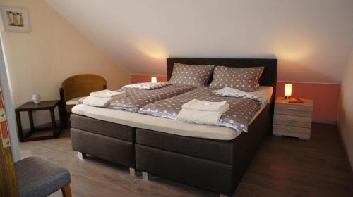 a bedroom with a large bed with two lights on it at Ferienhaus Dreilinge in Cochem