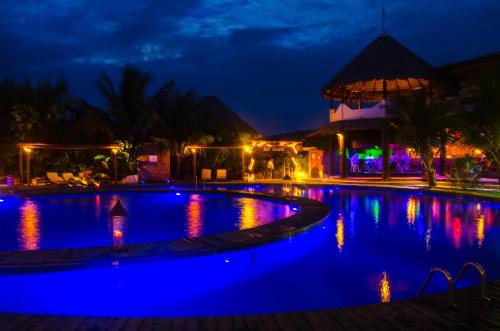 a swimming pool at night with blue lights at Long Beach in Canoa Quebrada