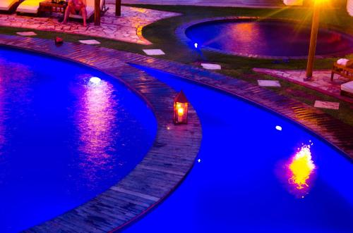 a couple of swimming pools with lights in them at Long Beach in Canoa Quebrada