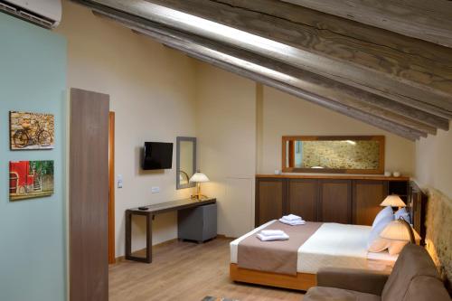 a bedroom with a bed and a desk and a couch at Elia Kentron in Chania Town