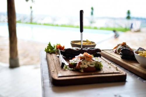 two plates of food sitting on top of a table at Pili Pili Boutique Hotel in Kigali
