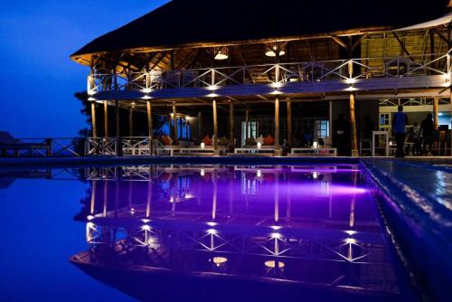 a resort with a swimming pool at night at Pili Pili Boutique Hotel in Kigali
