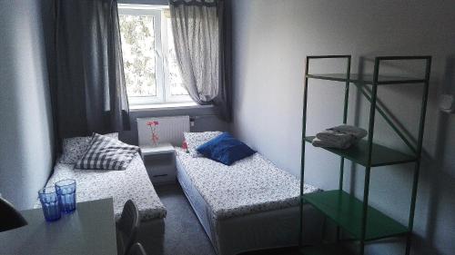 a bedroom with a bed and a desk at Słoneczny Warszawa in Warsaw
