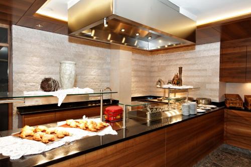 a kitchen with a counter with some food on it at Landhotel Schneider in Riedenburg