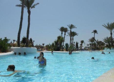 a group of people in a swimming pool at a resort at Zephir Hôtel & Spa in Zarzis