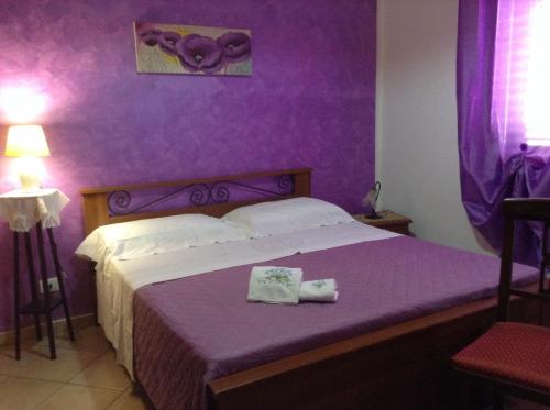 Ένα ή περισσότερα κρεβάτια σε δωμάτιο στο Villa Orizzonte