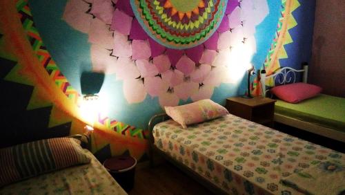 a childs room with two beds and a colorful wall at Shantihome in Izmir