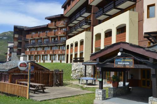 a building with a picnic table in front of it at Résidence Andromède in Belle Plagne
