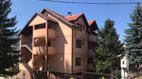 a large building with a red roof at Apartments Vila Hercegovina in Višegrad