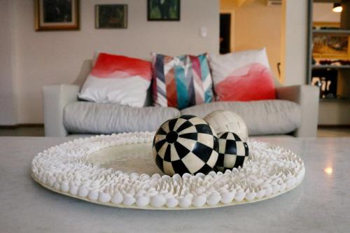 a table with a white plate with two balls on it at Hospedaria Conceitual in Florianópolis