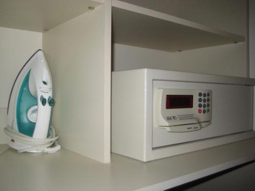 a white microwave sitting on top of a white shelf at Le Relais Lyonnais in Montreal