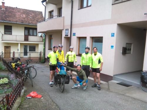 a group of men in yellow shirts standing next to a building at Apartment Dimitrieski in Višegrad