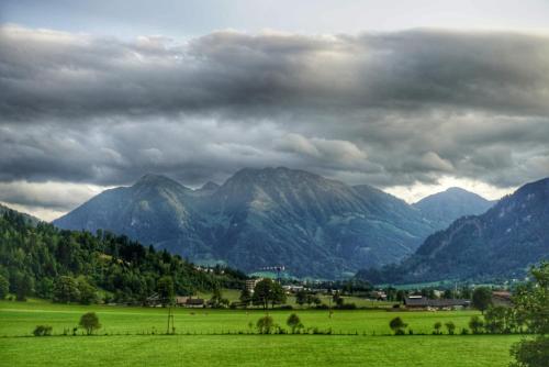 a green field with mountains in the background at Urlaub am Bauernhof Rothof in Sankt Johann im Pongau