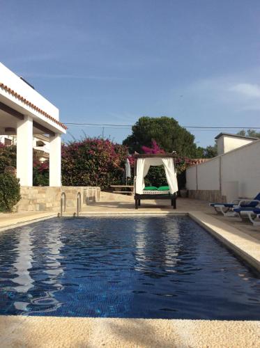 a swimming pool in a backyard with a tent next to a house at Apartamentos y Habitaciones KAI MARBELLA in Marbella