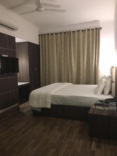 a hotel room with a bed and a window at Shiva Oasis Resort in Neemrana