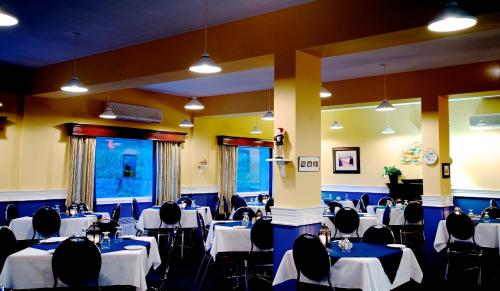 a banquet hall with tables and chairs and a podium at St Christopher's Hotel in Channel-Port aux Basques