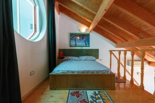 a bedroom with a bed and a large window at Holiday ApartHotel in Santa Maria