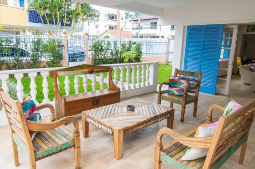 a patio with chairs and tables and a table and chairs at Hospedaria Conceitual in Florianópolis