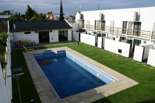 a large swimming pool on the side of a house at Arenas Blancas in Puerto Madryn