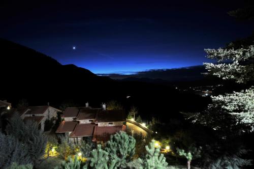 a house on a hill at night at Georgio's V Chalet Kalavrita in Kalavrita