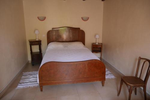 a bedroom with a wooden bed and a chair at A Cittadella in Vico