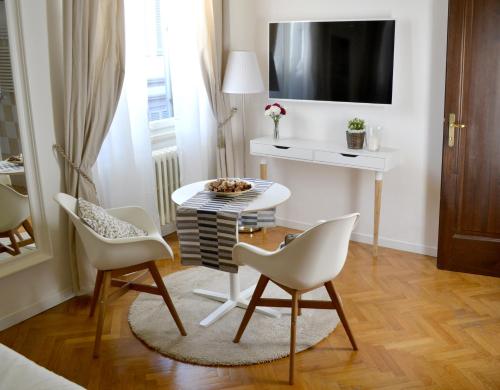a living room with a table and two chairs at Domus Duomo in Florence