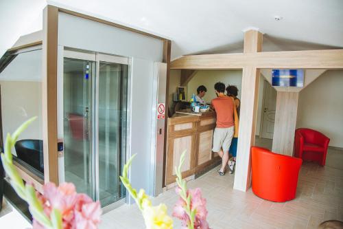 two people standing at a counter in a kitchen at Alina Hotel & Hostel in Uzhhorod