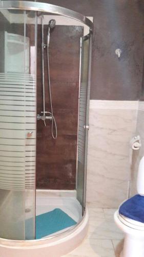 a shower stall in a bathroom with a toilet at Al Kawtar in Mohammedia