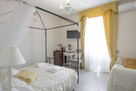 a bedroom with a bed and a table and a window at Borgo Pio 66 Suites in Rome