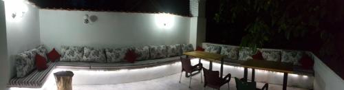 a room with a couch and a table and chairs at Guest House Major in Arandjelovac