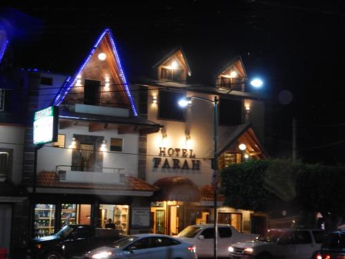 a hotel with a lit up facade at night at Hotel Farah in Nuevo San Juan Parangaricutiro