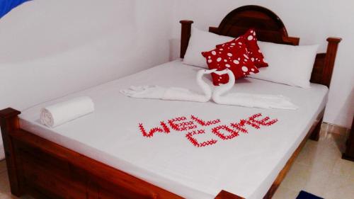 a bed with the words happy new year written on it at Priyavimana resort in Habarana