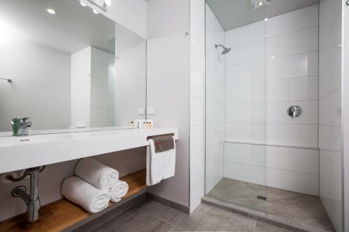 a bathroom with a sink and a shower at The Metrotel in New Plymouth