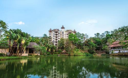 a view of a river with a building in the background at Jirung Health Village in Mae Rim