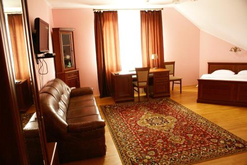 a living room with a couch and a bed at Complex Vivcharyk in Skole