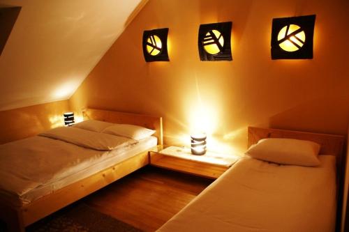 a bedroom with two beds and lights on the wall at Complex Vivcharyk in Skole