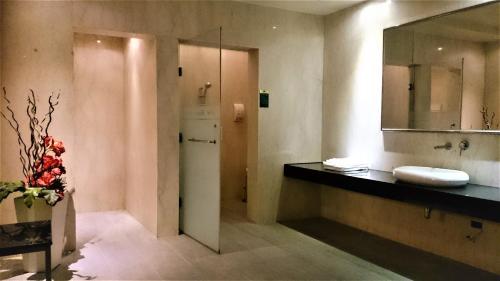 a bathroom with a sink and a mirror at Her Home Spa Motel Xinying in Xinying