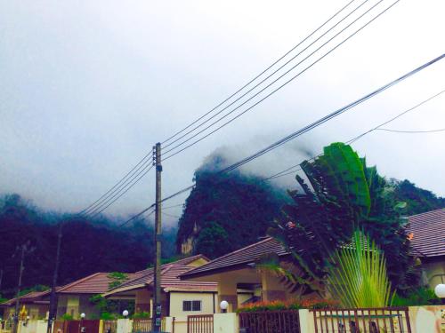 a house with smoke coming out of a mountain at Tiger Cave Home in Krabi