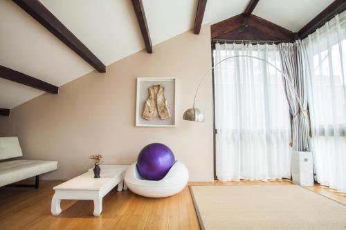 a living room with a large purple egg on the floor at The Bivou Lijiang in Lijiang