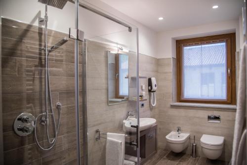 a bathroom with a shower and a toilet and a sink at Resort Monviso in Sanfront