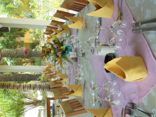 a table with wine glasses and napkins on a wall at Bolongs Passion in Cap Skirring