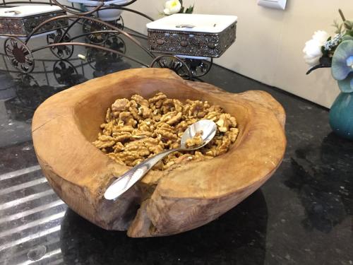 a bowl of food with a spoon in it at Hotel Halwachy in As Sulaymānīyah